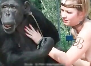 Filthy whore is doing her best to seduce a monkey for sex