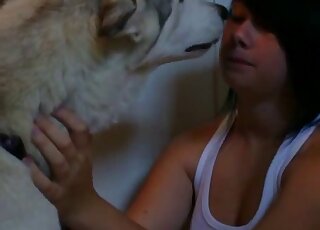 Emo girl dressed in white makes out happily with her animal here